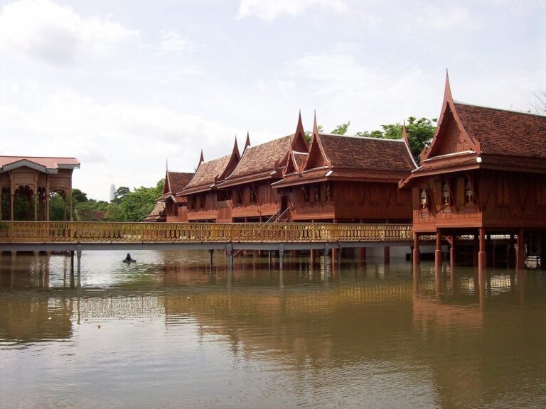 A teak pavilion standing over water at the Ancient City